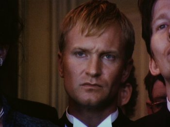Movie still from “The Celebration” (1998), directed by Thomas Vinterberg – A person wearing a suit and tie; Close Up shot, Low angle