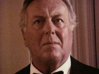 Movie still from “The Celebration” (1998), directed by Thomas Vinterberg – An older man wearing a suit and bow tie; Close Up shot, Low angle