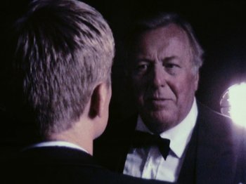 Movie still from “The Celebration” (1998), directed by Thomas Vinterberg – An older man looking at himself in the mirror; Close Up shot, Over the shoulder angle