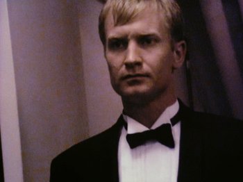 Movie still from “The Celebration” (1998), directed by Thomas Vinterberg – A man wearing a tuxedo and a bow tie; Close Up shot, Low angle