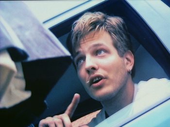 Movie still from “The Celebration” (1998), directed by Thomas Vinterberg – A man is looking out the window of a car; Close Up shot, Low angle