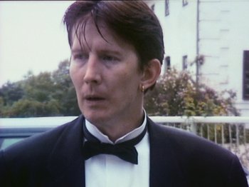 Movie still from “The Celebration” (1998), directed by Thomas Vinterberg – A man wearing a tuxedo and bow tie; Close Up shot, Low angle