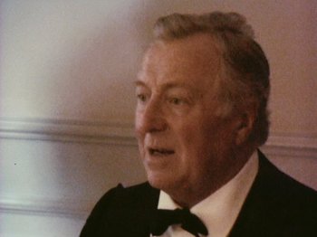 Movie still from “The Celebration” (1998), directed by Thomas Vinterberg – An older man wearing a tuxedo and bow tie; Close Up shot, High angle
