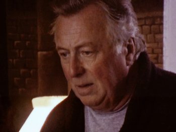 Movie still from “The Celebration” (1998), directed by Thomas Vinterberg – An older man is looking at the camera; Close Up shot, High angle