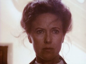 Movie still from “The Celebration” (1998), directed by Thomas Vinterberg – An older woman is looking at the camera; Close Up shot, Low angle