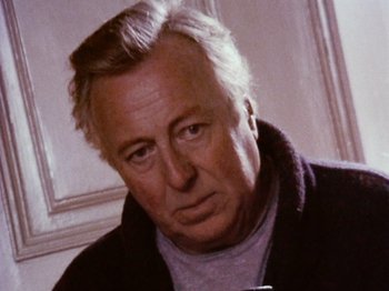 Movie still from “The Celebration” (1998), directed by Thomas Vinterberg – An older man is looking at the camera; Close Up shot, Low angle