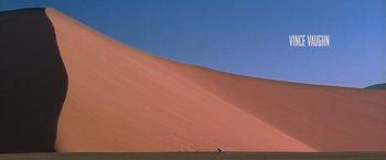 Movie still from “The Cell” (2000), directed by Tarsem Singh – A person standing in the middle of a desert; Extreme Wide shot, Low angle