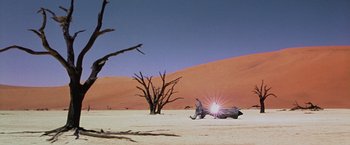 Movie still from “The Cell” (2000), directed by Tarsem Singh – A man sitting on top of an animal in the desert; Extreme Wide shot, Low angle