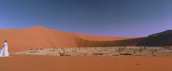 Movie still from “The Cell” (2000), directed by Tarsem Singh – A view of a desert landscape with sand dunes in the background; Extreme Wide shot, High angle