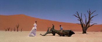 Movie still from “The Cell” (2000), directed by Tarsem Singh – A woman and a child in a desert setting; Wide shot, Low angle