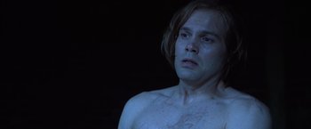Movie still from “The Cell” (2000), directed by Tarsem Singh – A shirtless man with long brown hair looking at the camera; Close Up shot, High angle