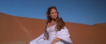 Movie still from “The Cell” (2000), directed by Tarsem Singh – A woman in a white dress is posing for a picture; Close Up shot, Low angle