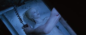 Movie still from “The Cell” (2000), directed by Tarsem Singh – A woman in a tub with a hand on her shoulder; Close Up shot, Overhead angle