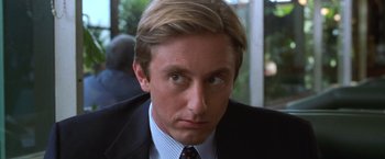 Movie still from “The Cell” (2000), directed by Tarsem Singh – A person wearing a suit and tie; Close Up shot, Over the shoulder angle