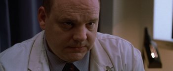 Movie still from “The Cell” (2000), directed by Tarsem Singh – A person wearing a white shirt and a tie; Close Up shot, Low angle