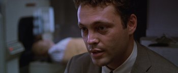 Movie still from “The Cell” (2000), directed by Tarsem Singh – A person wearing a suit and tie; Close Up shot, Low angle