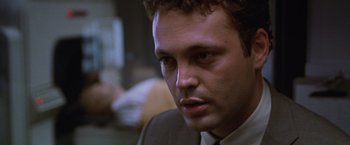 Movie still from “The Cell” (2000), directed by Tarsem Singh – A person wearing a suit and tie; Close Up shot, Low angle