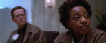 Movie still from “The Cell” (2000), directed by Tarsem Singh – Two people sitting at a table in front of each other; Close Up shot, Over the shoulder angle