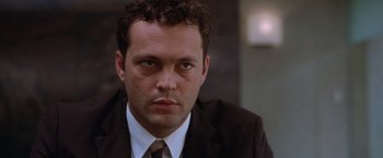 Movie still from “The Cell” (2000), directed by Tarsem Singh – A person wearing a suit and tie; Close Up shot, Low angle