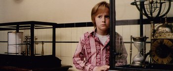 Movie still from “The Cell” (2000), directed by Tarsem Singh – A young boy standing in front of a bathroom window; Medium shot, Low angle