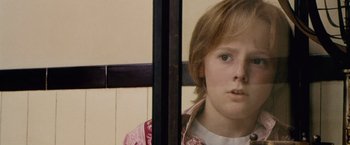 Movie still from “The Cell” (2000), directed by Tarsem Singh – A young boy looking out of a window; Close Up shot, High angle
