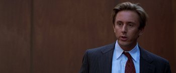 Movie still from “The Cell” (2000), directed by Tarsem Singh – A person wearing a suit and tie; Close Up shot, Over the shoulder angle