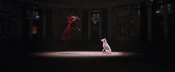 Movie still from “The Cell” (2000), directed by Tarsem Singh – A woman in a red dress and a white dog; Wide shot, Overhead angle