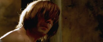 Movie still from “The Cell” (2000), directed by Tarsem Singh – A person with long brown hair; Close Up shot, Low angle