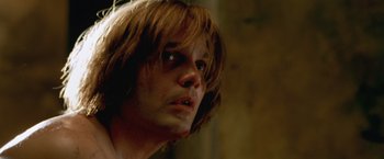 Movie still from “The Cell” (2000), directed by Tarsem Singh – A person with long brown hair; Close Up shot, Low angle