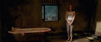 Movie still from “The Cell” (2000), directed by Tarsem Singh – Two women standing next to each other in front of a bathtub; Wide shot, High angle