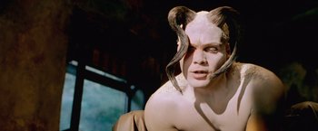 Movie still from “The Cell” (2000), directed by Tarsem Singh – A man with horns on his head and face; Close Up shot, High angle