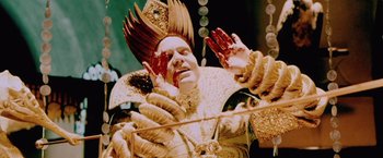 Movie still from “The Cell” (2000), directed by Tarsem Singh – A man in a costume is holding his hands up; Close Up shot, Overhead angle