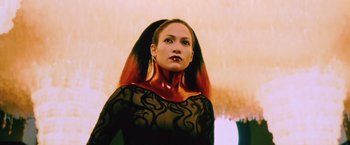 Movie still from “The Cell” (2000), directed by Tarsem Singh – A woman in a black dress with red hair; Close Up shot, Low angle