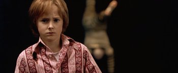 Movie still from “The Cell” (2000), directed by Tarsem Singh – A young boy wearing a red and white striped shirt; Close Up shot, Over the shoulder angle
