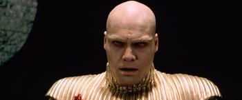 Movie still from “The Cell” (2000), directed by Tarsem Singh – A man with bald head and red eyes looking at the camera; Close Up shot, Low angle