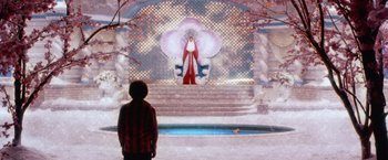 Movie still from “The Cell” (2000), directed by Tarsem Singh – A person standing in front of a statue of a woman; Wide shot, Over the shoulder angle