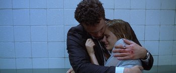 Movie still from “The Cell” (2000), directed by Tarsem Singh – A man and a woman hugging in a bathroom; Close Up shot, Low angle