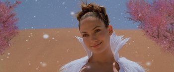 Movie still from “The Cell” (2000), directed by Tarsem Singh – A woman in a white dress with a white feather boa; Close Up shot, Low angle