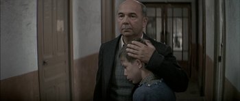 Movie still from “The Chorus” (2004), directed by Christophe Barratier – An older man and a young boy standing next to each other; Close Up shot, Over the shoulder angle