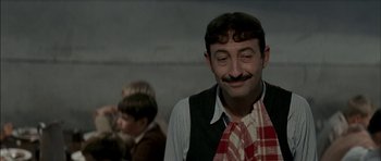 Movie still from “The Chorus” (2004), directed by Christophe Barratier – A man with a mustache wearing a vest and a tie; Close Up shot, Over the shoulder angle