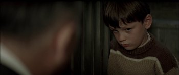 Movie still from “The Chorus” (2004), directed by Christophe Barratier – A young boy is looking out a window; Close Up shot, Over the shoulder angle