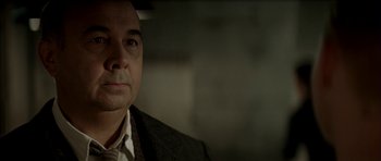 Movie still from “The Chorus” (2004), directed by Christophe Barratier – A person wearing a suit and tie; Close Up shot, Over the shoulder angle