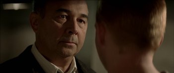 Movie still from “The Chorus” (2004), directed by Christophe Barratier – A person looking at another person in a mirror; Close Up shot, Over the shoulder angle