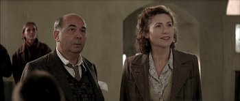 Movie still from “The Chorus” (2004), directed by Christophe Barratier – A man and a woman standing next to each other; Medium shot, Over the shoulder angle