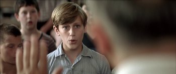 Movie still from “The Chorus” (2004), directed by Christophe Barratier – A young boy is looking into the distance; Close Up shot, Over the shoulder angle