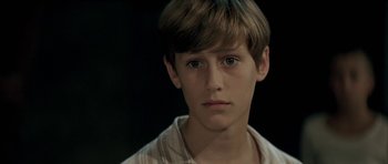 Movie still from “The Chorus” (2004), directed by Christophe Barratier – A young man with a serious look on his face; Close Up shot, High angle