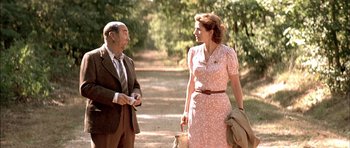 Movie still from “The Chorus” (2004), directed by Christophe Barratier – A man and a woman talking on the side of a road; Medium shot, Over the shoulder angle