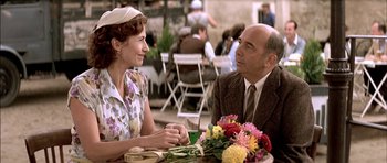 Movie still from “The Chorus” (2004), directed by Christophe Barratier – A man and a woman are sitting at a table; Close Up shot, Over the shoulder angle
