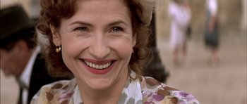 Movie still from “The Chorus” (2004), directed by Christophe Barratier – A person smiling; Close Up shot, Over the shoulder angle