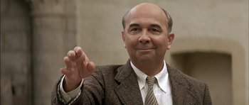Movie still from “The Chorus” (2004), directed by Christophe Barratier – A man in a suit and tie clapping his hands; Close Up shot, Low angle